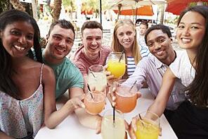 Group Of Friends Enjoying Drinks In Outdoor Restaurant