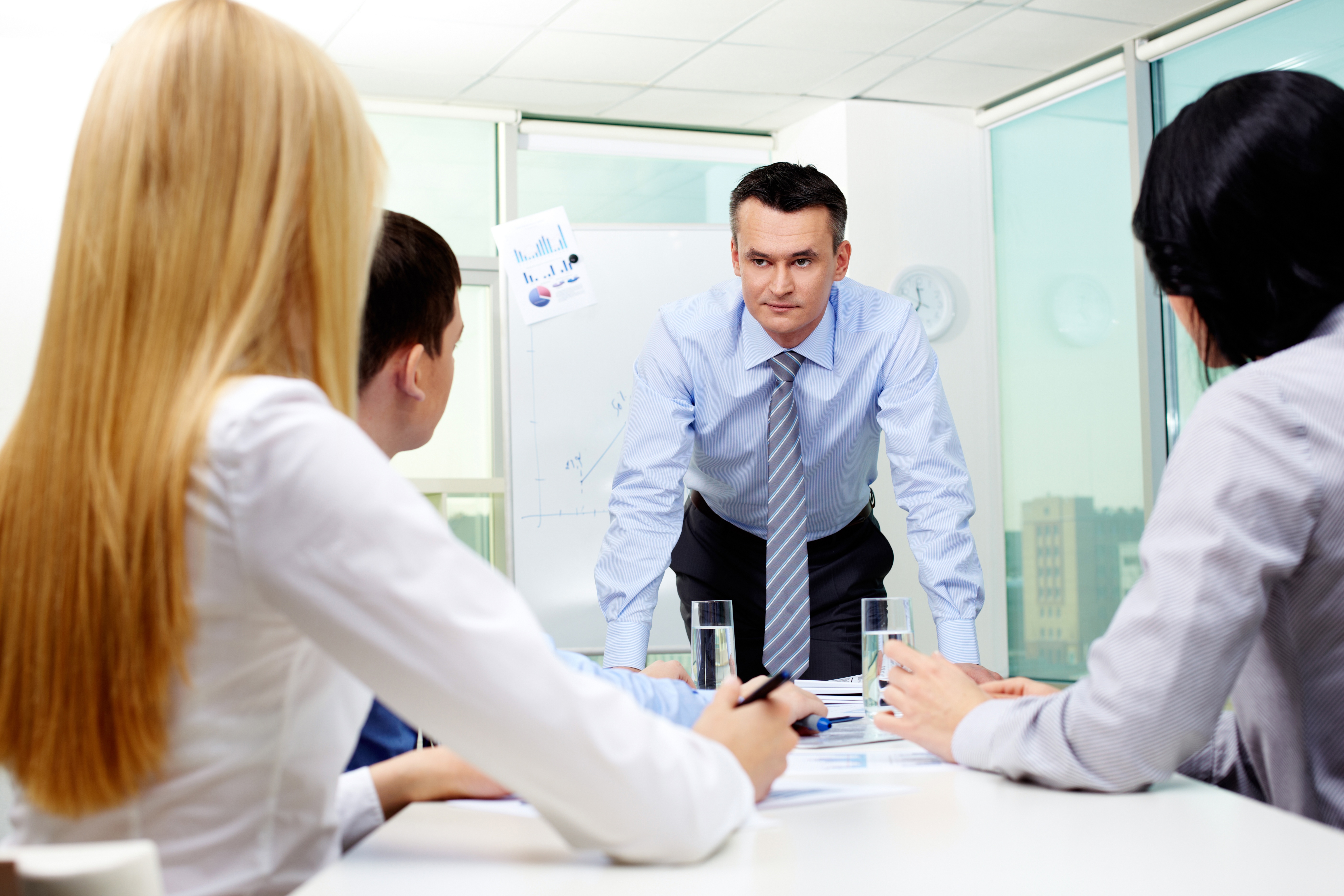 graphicstock-businessman-leaning-upon-table-looking-at-his-colleagues-pensively_SCGhKJOFbZ.jpg